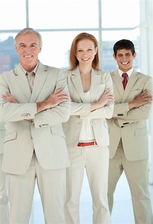 simsearch:400-04097612,k - Business team with folded arms standing in a line Fotografie stock - Microstock e Abbonamento, Codice: 400-04159743