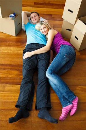 Couple lying on the floor with boxes around. Moving house Stock Photo - Budget Royalty-Free & Subscription, Code: 400-04150160