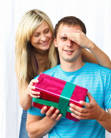 Woman giving a present to her boyfriend and covering his eyes with her hand Stock Photo - Budget Royalty-Free & Subscription, Code: 400-04150188