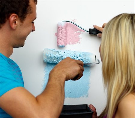 simsearch:400-04655735,k - Young couple painting new house with two colours. Stockbilder - Microstock & Abonnement, Bildnummer: 400-04150180