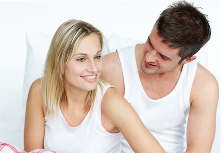 Young man and woman sitting on bed together Stock Photo - Budget Royalty-Free & Subscription, Code: 400-04150406