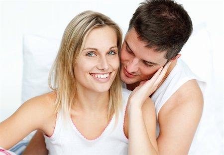 Attractive man hugging his beautiful girlfriend in bed Stock Photo - Budget Royalty-Free & Subscription, Code: 400-04150409