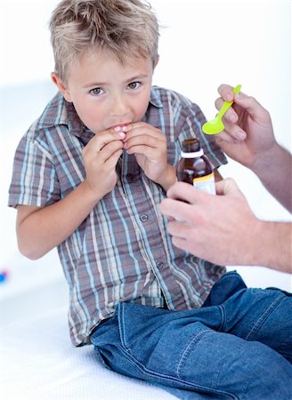Cold child taking syrup because of the flu Stock Photo - Budget Royalty-Free & Subscription, Code: 400-04150505