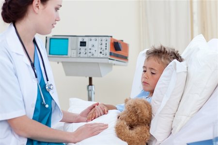 shaking hands kids - Beautiful female doctor examining a child in bed Stock Photo - Budget Royalty-Free & Subscription, Code: 400-04150565