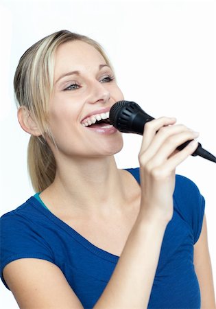 Beautiful woman singing on a microphone Stock Photo - Budget Royalty-Free & Subscription, Code: 400-04150632