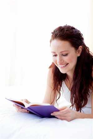 Beautiful happy woman reading a book in bed Stock Photo - Budget Royalty-Free & Subscription, Code: 400-04150665