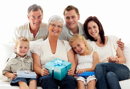 Family giving a present to grandmother for her birthday Stock Photo - Budget Royalty-Free & Subscription, Code: 400-04150748