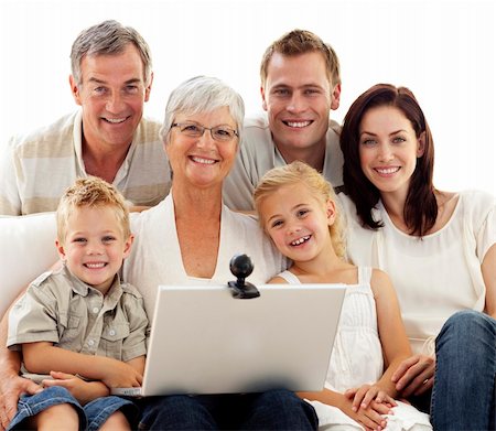simsearch:400-04575374,k - Happy family sitting on sofa using a laptop at home Stock Photo - Budget Royalty-Free & Subscription, Code: 400-04150741