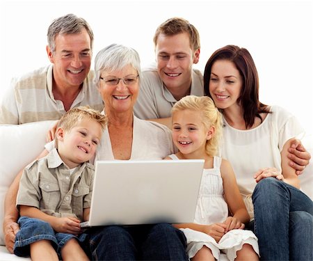 simsearch:400-04575374,k - Happy family sitting on sofa using a laptop in living-room Stock Photo - Budget Royalty-Free & Subscription, Code: 400-04150742