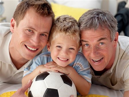 Portrait of smiling son, father and grandfather lying on floor Stock Photo - Budget Royalty-Free & Subscription, Code: 400-04150773