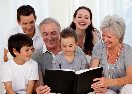 Family looking at a photograph album at home Stock Photo - Budget Royalty-Free & Subscription, Code: 400-04150782