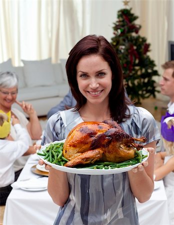 picture people eating thanksgiving dinner - Woman showing to the camera Christmas turkey for dinner Stock Photo - Budget Royalty-Free & Subscription, Code: 400-04150794