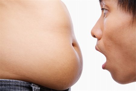 Man surprised looking on big belly, a concept for obese issue Photographie de stock - Aubaine LD & Abonnement, Code: 400-04150814