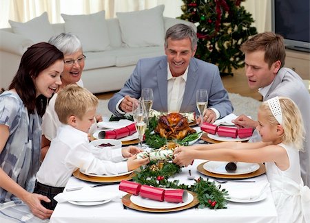 picture people eating thanksgiving dinner - Children pulling a Christmas cracker at home in a family dinner Stock Photo - Budget Royalty-Free & Subscription, Code: 400-04151061