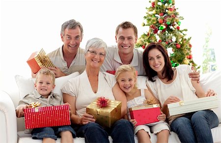 Happy family holding Christmas presents at home Stock Photo - Budget Royalty-Free & Subscription, Code: 400-04151093