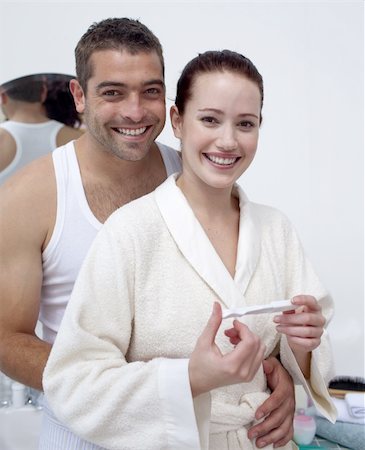 pregnant wife in bathroom - Happy young couple in bathroom looking at a positive pregnancy test Stock Photo - Budget Royalty-Free & Subscription, Code: 400-04151125