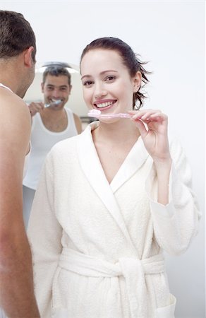 Attractive woman and man cleaning their teeth in bathroom Stock Photo - Budget Royalty-Free & Subscription, Code: 400-04151126