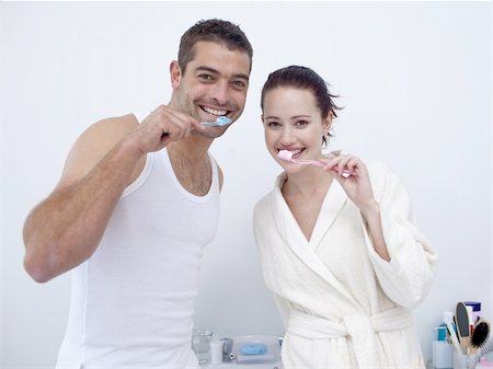 Attractive couple cleaning their teeth in bathroom Stock Photo - Budget Royalty-Free & Subscription, Code: 400-04151127
