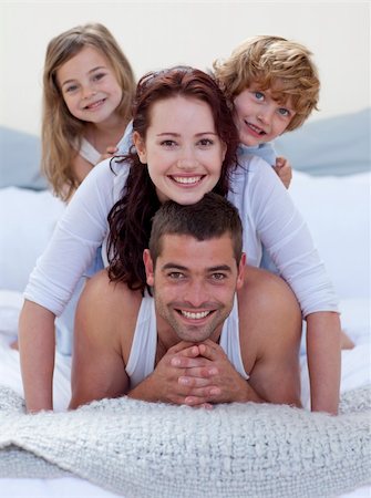 simsearch:400-04878558,k - Portrait of happy family having fun in bed together Stock Photo - Budget Royalty-Free & Subscription, Code: 400-04151166