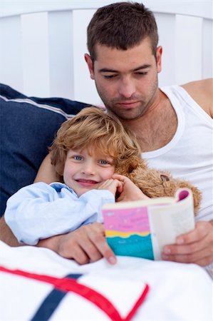 simsearch:400-05751566,k - Little son reading with his father a book in bed Stock Photo - Budget Royalty-Free & Subscription, Code: 400-04151218