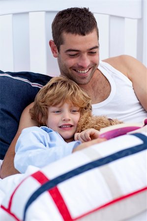 simsearch:400-05751566,k - Happy father and son reading a book together in bed together Stock Photo - Budget Royalty-Free & Subscription, Code: 400-04151219