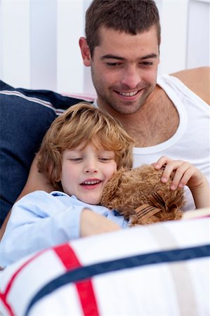 simsearch:400-05751566,k - Portrait of father and son reading a book in bed together Stock Photo - Budget Royalty-Free & Subscription, Code: 400-04151220