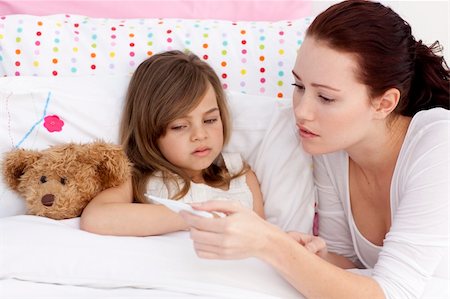 Mother taking sick daughter's temperature in bed Stock Photo - Budget Royalty-Free & Subscription, Code: 400-04151231