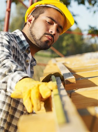 latin american construction worker on house roof with measuring tape. Stock Photo - Budget Royalty-Free & Subscription, Code: 400-04151373