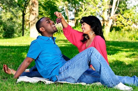 picture of the black man feeding the woman fruit - Young romantic couple having picnic in summer park Stock Photo - Budget Royalty-Free & Subscription, Code: 400-04151391