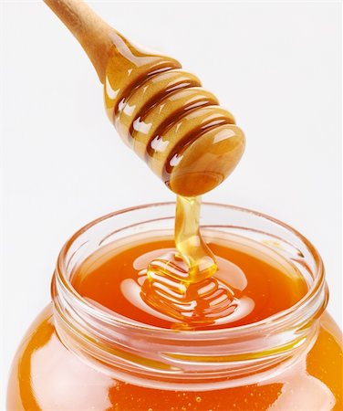 pouring wheat - Honey dipper and full honey pot isolated on a white background Foto de stock - Super Valor sin royalties y Suscripción, Código: 400-04151566