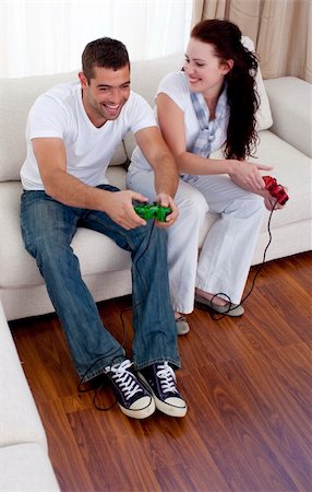 Happy friends playing video games in living-room Stock Photo - Budget Royalty-Free & Subscription, Code: 400-04151979