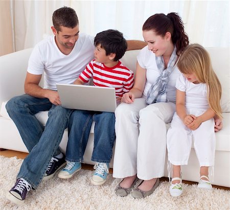 simsearch:400-04575374,k - Happy family at home using a laptop Stock Photo - Budget Royalty-Free & Subscription, Code: 400-04151984