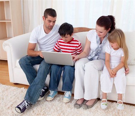 simsearch:400-04575374,k - Happy family at home using a laptop Stock Photo - Budget Royalty-Free & Subscription, Code: 400-04151982