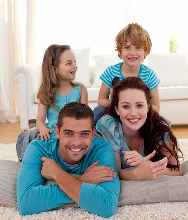 Parents, daughter and son lying on floor in living-room Stock Photo - Budget Royalty-Free & Subscription, Code: 400-04151997