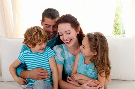 Family in living-room sitting on sofa having fun together Stock Photo - Budget Royalty-Free & Subscription, Code: 400-04151999