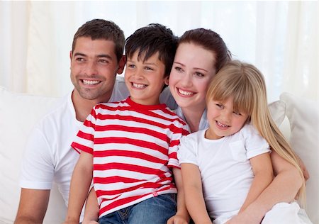 Happy family in living-room sitting on sofa together Stock Photo - Budget Royalty-Free & Subscription, Code: 400-04151991