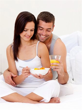 Happy couple having nutritive breakfast sitting in bed Stock Photo - Budget Royalty-Free & Subscription, Code: 400-04152076