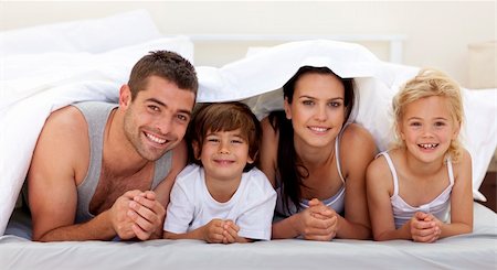 face down lying girl - Happy young family playing in parent's bed Stock Photo - Budget Royalty-Free & Subscription, Code: 400-04152114