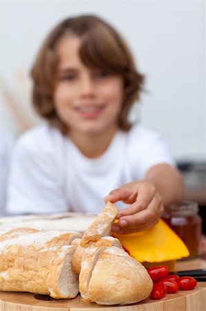 Close-up of child's hand taking bread in the kitchen Stock Photo - Budget Royalty-Free & Subscription, Code: 400-04152397