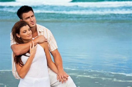 simsearch:400-06751687,k - A young man and woman embracing as a romantic couple on a beach Stock Photo - Budget Royalty-Free & Subscription, Code: 400-04153091