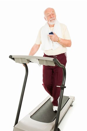 simsearch:400-05144946,k - Senior man enjoys music on his mp3 player while he exercises.  Isolated. Photographie de stock - Aubaine LD & Abonnement, Code: 400-04153217