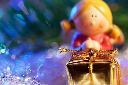 Christmas gift in golden box with angel girl under the christmas tree Stock Photo - Budget Royalty-Free & Subscription, Code: 400-04153331