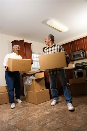 Smiling senior african american man and woman carry moving boxes into a new home.  Vertical shot. Stock Photo - Budget Royalty-Free & Subscription, Code: 400-04164286