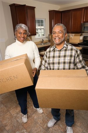 elderly black woman indoors - Portrait of smiling senior african american man and woman with moving boxes in a new home.   Vertical shot. Stock Photo - Budget Royalty-Free & Subscription, Code: 400-04164287