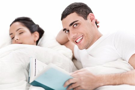 simsearch:400-04123173,k - Woman sleeping and man happily reading book in bed over white background Stock Photo - Budget Royalty-Free & Subscription, Code: 400-04165086