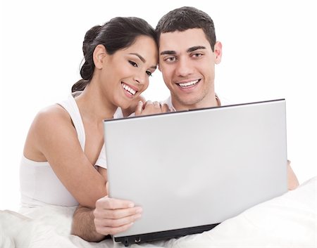 Couple sitting in bed with laptop cover white sheet Stock Photo - Budget Royalty-Free & Subscription, Code: 400-04165264