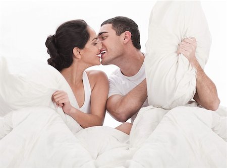 Couple kissing and playing on bed in bedroom, in passion over white background Stock Photo - Budget Royalty-Free & Subscription, Code: 400-04165267