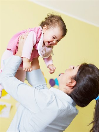 simsearch:400-04165323,k - mom lifting her daughter up and smiling. Vertical shape Photographie de stock - Aubaine LD & Abonnement, Code: 400-04165352