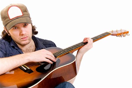 rocker guitarist - guitarist playing an acoustic guitar seated over white Stock Photo - Budget Royalty-Free & Subscription, Code: 400-04165967