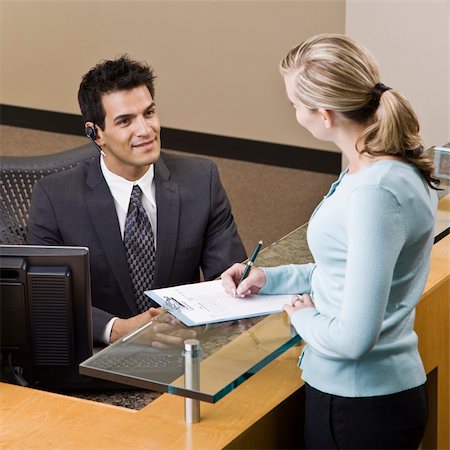 simsearch:400-04167547,k - Businesswoman talking to receptionist.  Square framed shot. Stock Photo - Budget Royalty-Free & Subscription, Code: 400-04167446